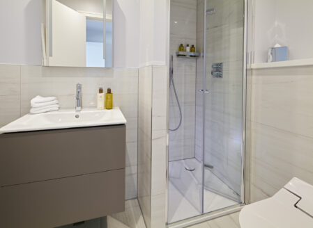 The en-suite bathroom features a shower room