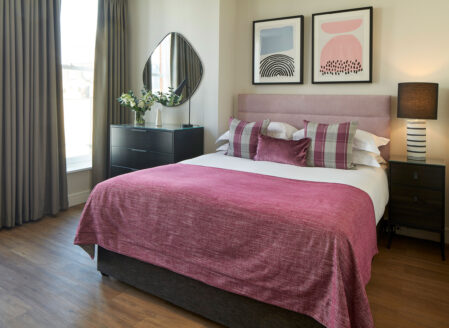 The king-size bed in a superior open plan apartment
