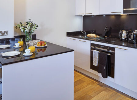 The open plan kitchen area has a bar area for dining