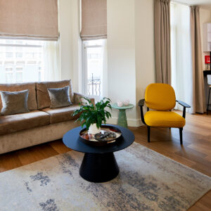 An open-plan living area leading onto the kitchen in a superior one-bedroom apartment