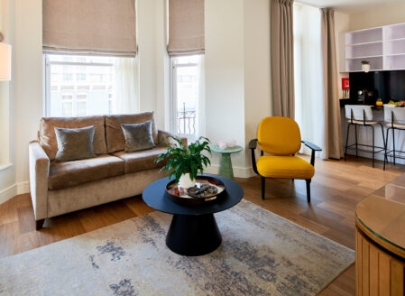 An open-plan living area leading onto the kitchen in a superior one-bedroom apartment