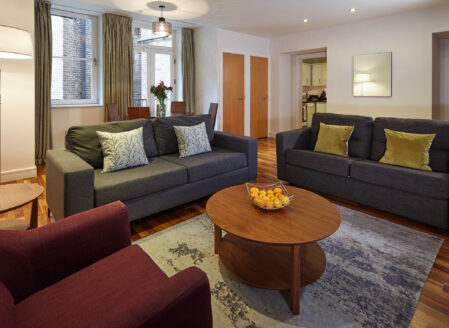 The open plan living and dining area in a luxury one-bedroom apartment