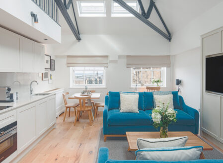 The lower level open plan living space of a one-bedroom penthouse