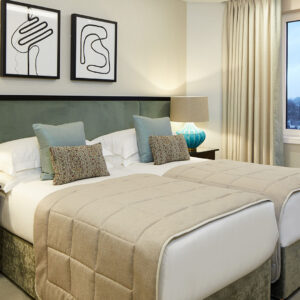 The second bedroom is configured with twin beds.