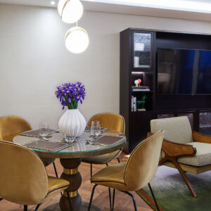 The open plan living space includes a dining area comfortably seating four people.