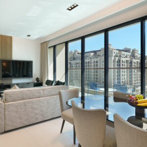 Open plan living room and kitchen with views of Palm Jumeirah