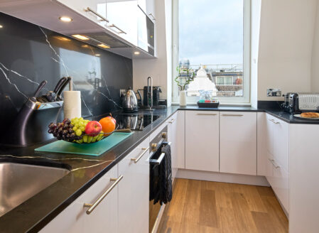 A full size kitchen for dining and safe meal preparation in a two bedroom apartment