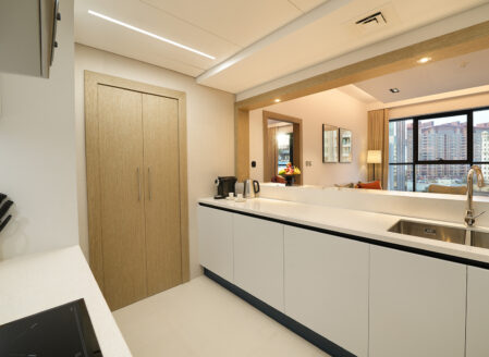 A separate utility area behind the kitchen with washer/dryer