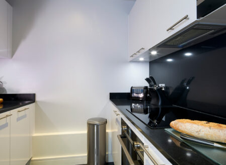 The kitchen is fully equipped and separate from the living area